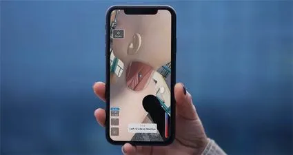 A hero image of a hand holding a smartphone displaying a 3D asset depicting neck muscles